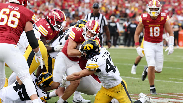 Sep 6, 2025; Ames, Iowa, USA; Iowa Hawkeyes linebacker Karson Sharar (43) tackles Iowa State Cyclones running back Carson Hansen (26) during the second half at Jack Trice Stadium. Mandatory Credit: Reese Strickland-Imagn Images