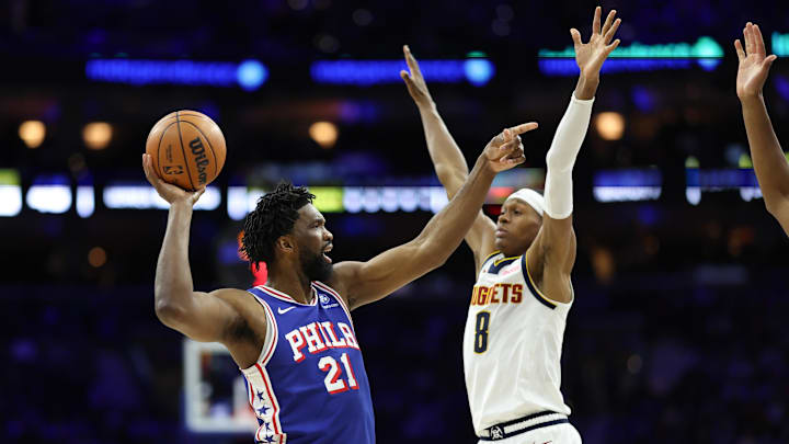 Jan 5, 2026; Philadelphia, Pennsylvania, USA; Philadelphia 76ers center Joel Embiid (21) controls the ball against Denver Nuggets guard Peyton Watson (8) during the second quarter at Xfinity Mobile Arena. Mandatory Credit: Bill Streicher-Imagn Images