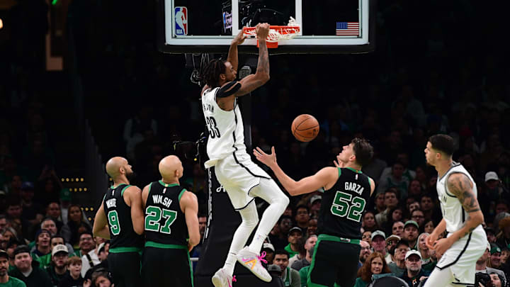 Nov 21, 2025; Boston, Massachusetts, USA; Brooklyn Nets center Nic Claxton (33) dunks the ball while Boston Celtics center Luka Garza (52) looks on during the second half at TD Garden. Mandatory Credit: Bob DeChiara-Imagn Images