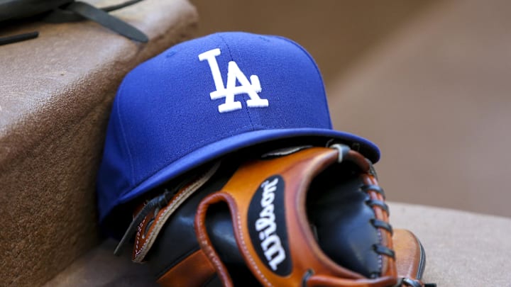 Aug 16, 2019; Atlanta, GA, USA; Detailed view of Los Angeles Dodgers hat and glove in the dugout against the Atlanta Braves in the first inning at SunTrust Park. Mandatory Credit: Brett Davis-Imagn Images Aug 16, 2019; Atlanta, GA, USA; Detailed view of Los Angeles Dodgers hat and glove in the dugout against the Atlanta Braves in the first inning at SunTrust Park. Mandatory Credit: Brett Davis-Imagn Images