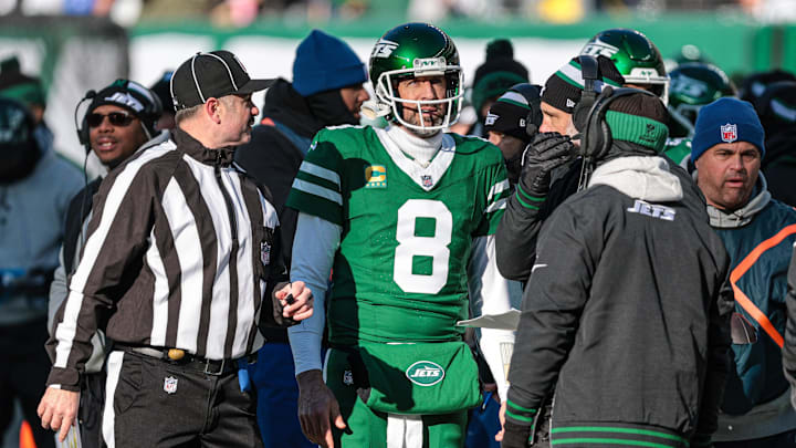 Dec 22, 2024; East Rutherford, New Jersey, USA; New York Jets quarterback Aaron Rodgers (8) talks with head coach Jeff Ulbrich during the first half against the Los Angeles Rams at MetLife Stadium. Mandatory Credit: Vincent Carchietta-Imagn Images