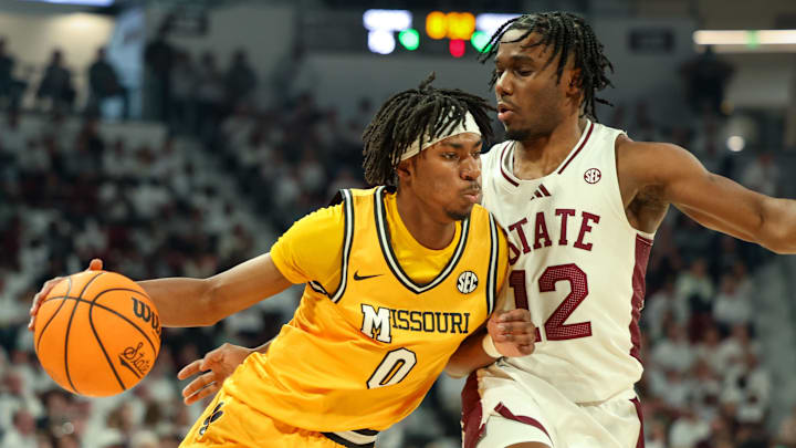 Feb 1, 2025; Starkville, Mississippi, USA; Missouri Tigers guard Anthony Robinson II (0) drives to the basket against Mississippi State Bulldogs guard Josh Hubbard (12) during the first half at Humphrey Coliseum. Mandatory Credit: Wesley Hale-Imagn Images