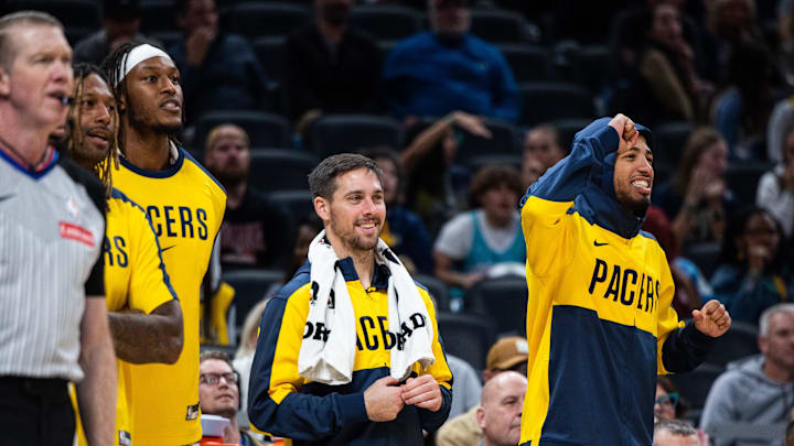 Oct 17, 2024; Indianapolis, Indiana, USA; Indiana Pacers guard Tyrese Haliburton (0) guard T.J. McConnell (9) and center Myles Turner (33) cheer from the bench  in the second half against the Charlotte Hornets at Gainbridge Fieldhouse. Mandatory Credit: Trevor Ruszkowski-Imagn Images