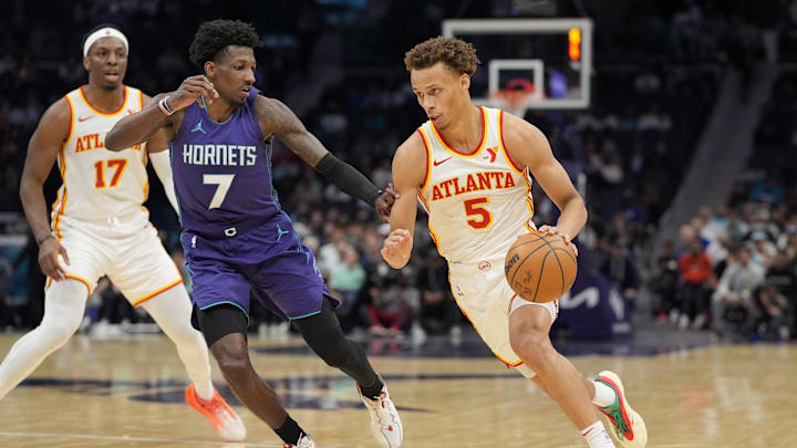 Mar 18, 2025; Charlotte, North Carolina, USA; Atlanta Hawks guard Dyson Daniels (5) goes to the basket against Charlotte Hornets guard Damion Baugh (7) during second quarter at Spectrum Center. Mandatory Credit: Jim Dedmon-Imagn Images