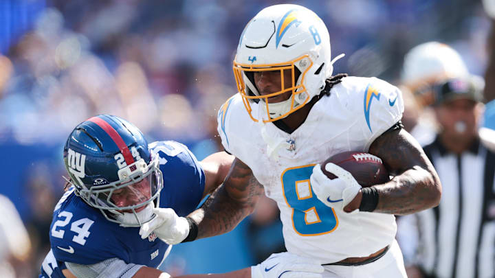 Los Angeles Chargers running back Omarion Hampton rushes as New York Giants safety Dane Belton defends. Los Angeles Chargers running back Omarion Hampton rushes as New York Giants safety Dane Belton defends.