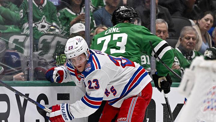 Apr 11, 2026; Dallas, Texas, USA; New York Rangers defenseman Adam Fox (23) checks Dallas Stars left wing Adam Erne (73) during the second period at the American Airlines Center. 