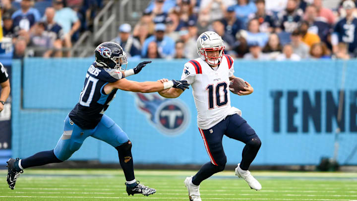 Nov 3, 2024; Nashville, Tennessee, USA; New England Patriots quarterback Drake Maye (10) stiff arms Tennessee Titans linebacker Harold Landry III (58) during the second half at Nissan Stadium. Mandatory Credit: Steve Roberts-Imagn Images Nov 3, 2024; Nashville, Tennessee, USA; New England Patriots quarterback Drake Maye (10) stiff arms Tennessee Titans linebacker Harold Landry III (58) during the second half at Nissan Stadium. Mandatory Credit: Steve Roberts-Imagn Images