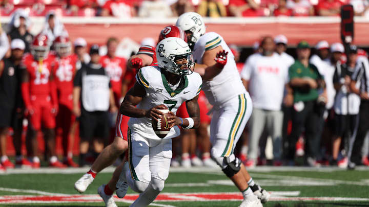 Sep 7, 2024; Salt Lake City, Utah, USA; Baylor Bears quarterback Dequan Finn (7) scrambles out of the pocket against the Utah Utes during the fourth quarter at Rice-Eccles Stadium. Mandatory Credit: Rob Gray-Imagn Images