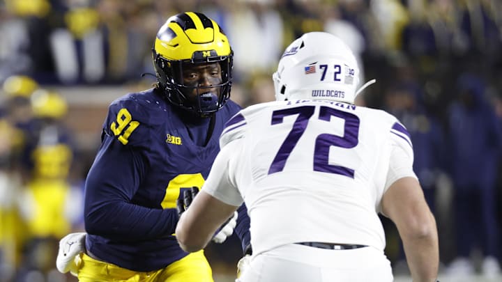 Nov 23, 2024; Ann Arbor, Michigan, USA;  Michigan Wolverines defensive end Cameron Brandt (91) rushes on defense at Northwestern Wildcats offensive lineman Caleb Tiernan (72) in the second half t Michigan Stadium. Mandatory Credit: Rick Osentoski-Imagn Images