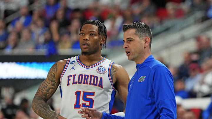 Mar 23, 2025; Raleigh, NC, USA; Florida Gators head coach Todd Golden and Florida Gators guard Will Richard (5) huddle up during the second half against the Connecticut Huskies in the second round of the NCAA Tournament at Lenovo Center. Mandatory Credit: Bob Donnan-Imagn Images