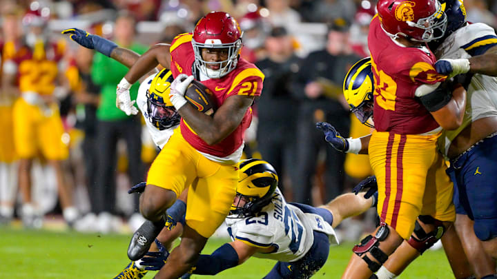 Oct 11, 2025; Los Angeles, California, USA; USC Trojans running back Bryan Jackson (21) gets past Michigan Wolverines linebacker Cole Sullivan (23) and runs for a touchdown in the second half at United Airlines Field at the Los Angeles Memorial Coliseum. Mandatory Credit: Jayne Kamin-Oncea-Imagn Images Oct 11, 2025; Los Angeles, California, USA; USC Trojans running back Bryan Jackson (21) gets past Michigan Wolverines linebacker Cole Sullivan (23) and runs for a touchdown in the second half at United Airlines Field at the Los Angeles Memorial Coliseum. Mandatory Credit: Jayne Kamin-Oncea-Imagn Images