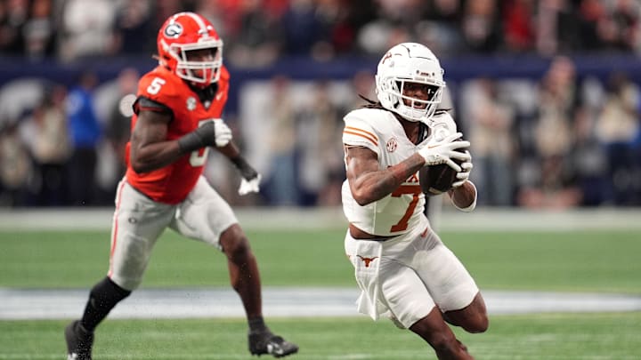 Dec 7, 2024; Atlanta, GA, USA; Texas Longhorns wide receiver Isaiah Bond (7) makes a catch past Georgia Bulldogs linebacker Raylen Wilson (5) during the first half in the 2024 SEC Championship game at Mercedes-Benz Stadium. Mandatory Credit: Dale Zanine-Imagn Images