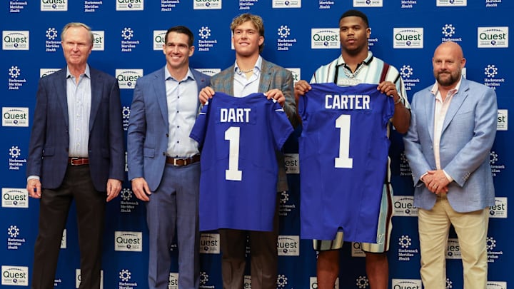 Apr 25, 2025; East Rutherford, NJ, US; New York Giants president John Mara (far left), general manager Joe Schoen (left), Jaxson Dart, Abdul Carter, and head coach Brian Daboll (right) pose for photos prior to the start of the press conference to introduce the Giants first round draft picks.  Mandatory Credit: Thomas Salus-Imagn Images