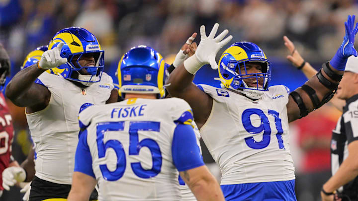 Nov 23, 2025; Inglewood, California, USA; Los Angeles Rams defensive end Kobie Turner (91) celebrates with linebacker Jared Verse (8) and defensive end Braden Fiske (55) after sacking quarterback Baker Mayfield (not pictured) during the second quarter at SoFi Stadium. Mandatory Credit: Jayne Kamin-Oncea-Imagn Images Nov 23, 2025; Inglewood, California, USA; Los Angeles Rams defensive end Kobie Turner (91) celebrates with linebacker Jared Verse (8) and defensive end Braden Fiske (55) after sacking quarterback Baker Mayfield (not pictured) during the second quarter at SoFi Stadium. Mandatory Credit: Jayne Kamin-Oncea-Imagn Images