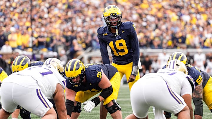 Michigan quarterback Bryce Underwood (19) talks to teammates before a play against Washington during the second half at Michigan Stadium in Ann Arbor on Saturday, Oct. 18, 2025.