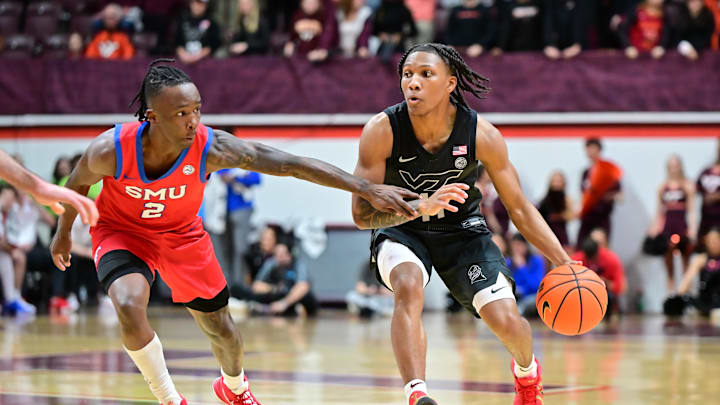 Feb 5, 2025; Blacksburg, Virginia, USA; Virginia Tech Hokies guard Ben Hammond (11) controls the ball while being defended by Southern Methodist Mustangs guard Boopie Miller (2) during the second half at Cassell Coliseum. Mandatory Credit: Brian Bishop-Imagn Images