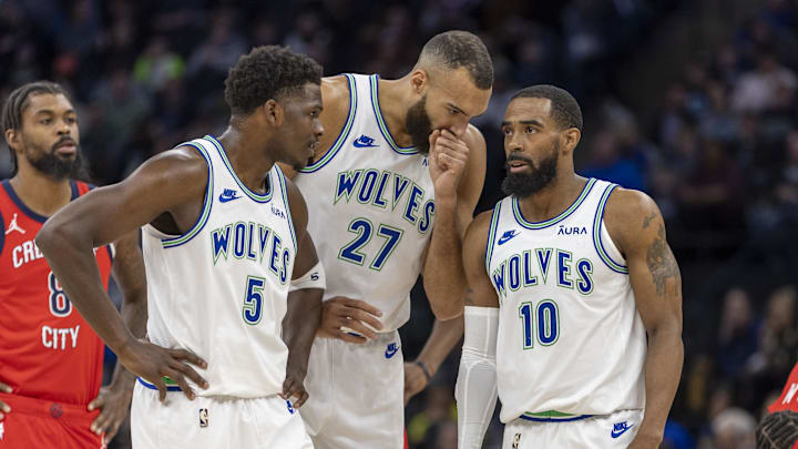 Jan 3, 2024; Minneapolis, Minnesota, USA; Minnesota Timberwolves guard Anthony Edwards (5), center Rudy Gobert (27) and guard Mike Conley (10) talk during a free throw against the New Orleans Pelicans in the first half at Target Center. Mandatory Credit: Jesse Johnson-Imagn Images