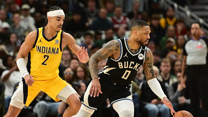 Apr 27, 2025; Milwaukee, Wisconsin, USA; Milwaukee Bucks guard Damian Lillard (0) drives for the basket against Indiana Pacers guard Andrew Nembhard (2) in the first quarter during game four of first round for the 2024 NBA Playoffs at Fiserv Forum. Lillard left the game early in the in the first quarter with an injury. Mandatory Credit: Benny Sieu-Imagn Images