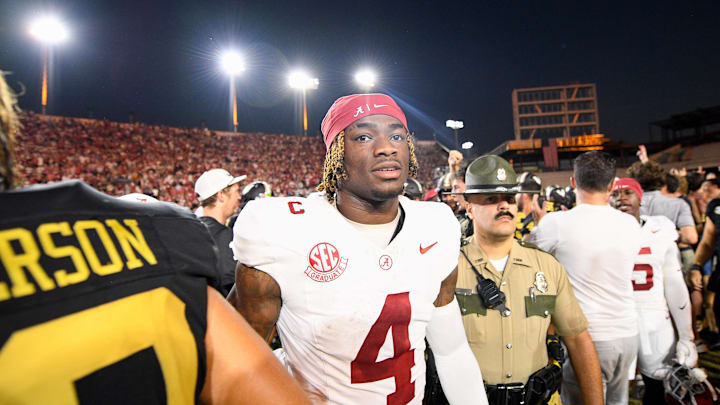 Oct 5, 2024; Nashville, Tennessee, USA;  Alabama Crimson Tide quarterback Jalen Milroe (4) shakes hands with Vanderbilt Commodores wide receiver Micah Bell (26) after a game at FirstBank Stadium. Mandatory Credit: Steve Roberts-Imagn Images