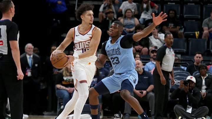 Mar 30, 2026; Memphis, Tennessee, USA; Phoenix Suns guard Koby Brea (14) handles the ball as Memphis Grizzlies forward Cedric Coward (23) defends during the fourth quarter at FedExForum. Mandatory Credit: Petre Thomas-Imagn Images