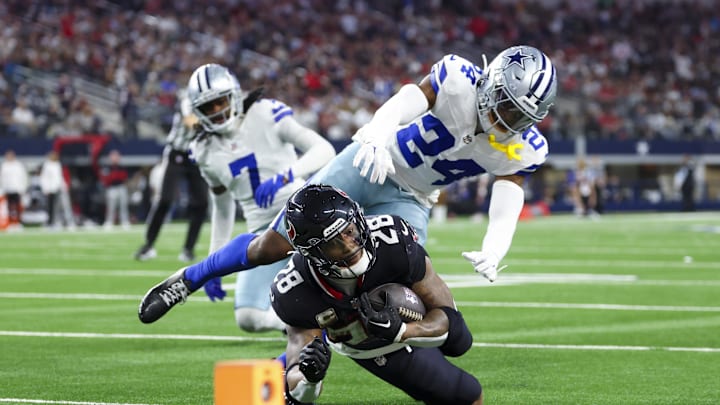 Nov 18, 2024; Arlington, Texas, USA; Houston Texans running back Joe Mixon (28) dives for yardage past Dallas Cowboys safety Israel Mukuamu (24) during the second half at AT&T Stadium. Mandatory Credit: Kevin Jairaj-Imagn Images