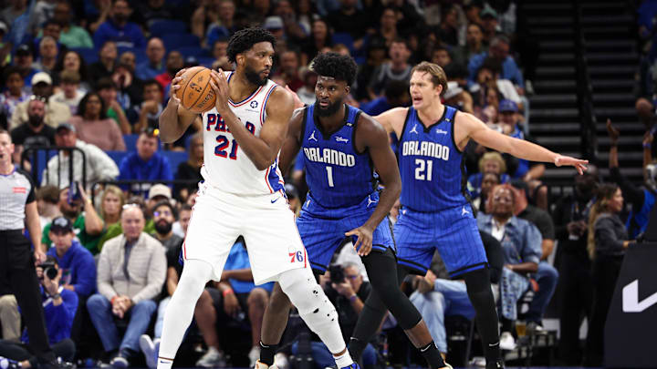 Nov 15, 2024; Orlando, Florida, USA; Philadelphia 76ers center Joel Embiid (21) is guarded by Orlando Magic forward Jonathan Isaac (1) in the third quarter at Kia Center. Mandatory Credit: Nathan Ray Seebeck-Imagn Images