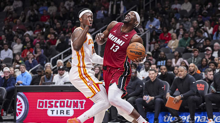 Feb 24, 2025; Atlanta, Georgia, USA; Miami Heat center Bam Adebayo (13) tries to get past Atlanta Hawks forward Onyeka Okongwu (17) during the first half at State Farm Arena. Mandatory Credit: Dale Zanine-Imagn Images