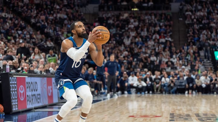 Apr 13, 2025; Minneapolis, Minnesota, USA; Minnesota Timberwolves guard Mike Conley (10) shoots a three-point shot against the Utah Jazz in the second quarter at Target Center. Mandatory Credit: Matt Blewett-Imagn Images