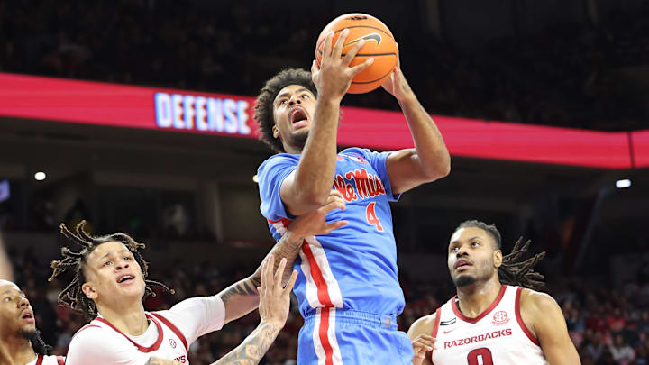 Jan 8, 2025; Fayetteville, Arkansas, USA; Ole Miss Rebels forward Jaemyn Brakefield (4) shoots in the first half as  Arkansas Razorbacks forwards Trevon Brazile (4) and Jonas Aidoo (9) defends at Bud Walton Arena. Mandatory Credit: Nelson Chenault-Imagn Images