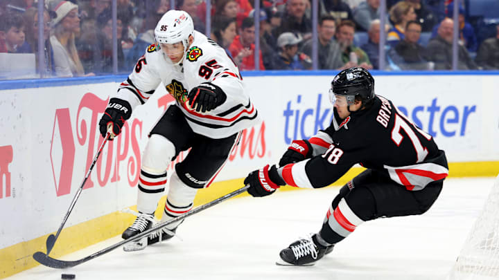 Dec 27, 2024; Buffalo, New York, USA;  Chicago Blackhawks right wing Ilya Mikheyev (95) and Buffalo Sabres defenseman Jacob Bryson (78) go after a loose puck during the first period at KeyBank Center. Mandatory Credit: Timothy T. Ludwig-Imagn Images