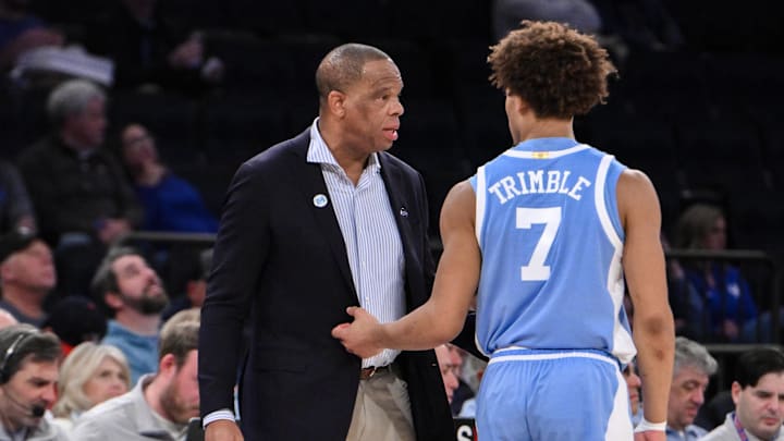 Dec 21, 2024; New York, NY, USA; North Carolina Tar Heels head coach Hubert Davis talks to guard Seth Trimble (7) during the first half against the UCLA Bruins at Madison Square Garden. Mandatory Credit: John Jones-Imagn Images