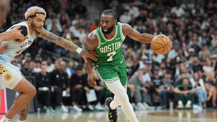 Mar 29, 2025; San Antonio, Texas, USA;  Boston Celtics guard Jaylen Brown (7) dribbles past San Antonio Spurs forward Jeremy Sochan (10) in the second half at Frost Bank Center. Mandatory Credit: Daniel Dunn-Imagn Images