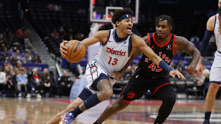 Jan 29, 2025; Washington, District of Columbia, USA; Washington Wizards guard Jordan Poole (13) drives to the basket as Toronto Raptors guard Davion Mitchell (45) defends in the first quarter at Capital One Arena. Mandatory Credit: Geoff Burke-Imagn Images