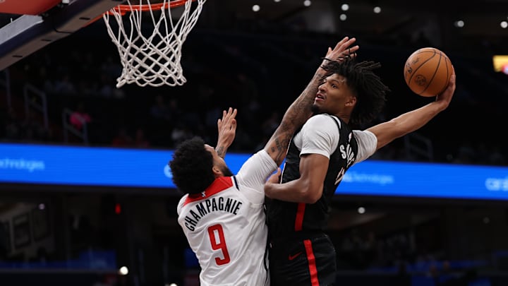 Feb 26, 2025; Washington, District of Columbia, USA; Portland Trail Blazers guard Shaedon Sharpe (17) dunks the ball over Washington Wizards forward Justin Champagnie (9) in the first half at Capital One Arena. Mandatory Credit: Geoff Burke-Imagn Images