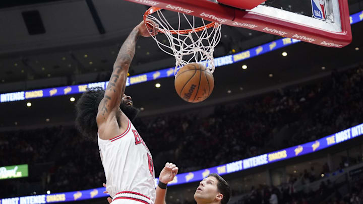 Chicago Bulls guard Coby White (0) dunks the ball on Indiana Pacers forward Doug McDermott (20).