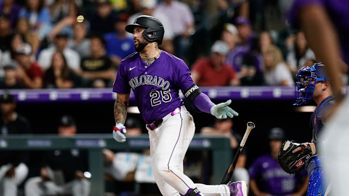 Aug 18, 2025; Denver, Colorado, USA; Colorado Rockies first baseman Warming Bernabel (25) watches his ball on a walk off RBI single in the ninth inning against the Los Angeles Dodgers at Coors Field. 