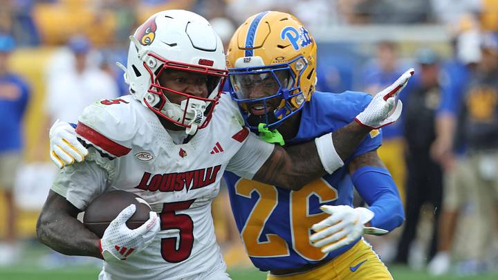 Sep 27, 2025; Pittsburgh, Pennsylvania, USA; Louisville Cardinals wide receiver Caullin Lacy (5) runs after a catch against Pittsburgh Panthers defensive back Allen Bryant (26) during the fourth quarter at Acrisure Stadium. Mandatory Credit: Charles LeClaire-Imagn Images Sep 27, 2025; Pittsburgh, Pennsylvania, USA; Louisville Cardinals wide receiver Caullin Lacy (5) runs after a catch against Pittsburgh Panthers defensive back Allen Bryant (26) during the fourth quarter at Acrisure Stadium. Mandatory Credit: Charles LeClaire-Imagn Images