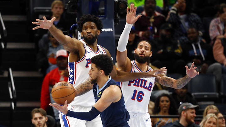 Nov 20, 2024; Memphis, Tennessee, USA; Philadelphia 76ers center Joel Embiid (21) and forward Caleb Martin (16) defend as Memphis Grizzlies guard Scotty Pippen Jr. (1) drives to the basket during the first half at FedExForum. Mandatory Credit: Petre Thomas-Imagn Images