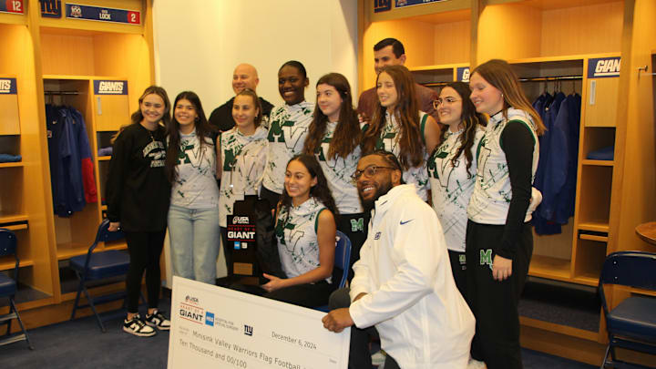 December 6, 2024; East Rutherford, NJ, USA; New York Giants OLB Kayvon Thibodeaux presents the team's annual 'Heart of a Giant' award to Vanessa Tepper of Minisink Valley High School.