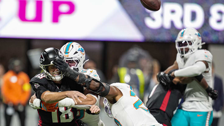 Atlanta Falcons quarterback Kirk Cousins (18) is hit by Miami Dolphins linebacker Jaelan Phillips (15) and linebacker Jordyn Brooks (20) as he releases the ball during the first quarter at Mercedes-Benz Stadium. Atlanta Falcons quarterback Kirk Cousins (18) is hit by Miami Dolphins linebacker Jaelan Phillips (15) and linebacker Jordyn Brooks (20) as he releases the ball during the first quarter at Mercedes-Benz Stadium.