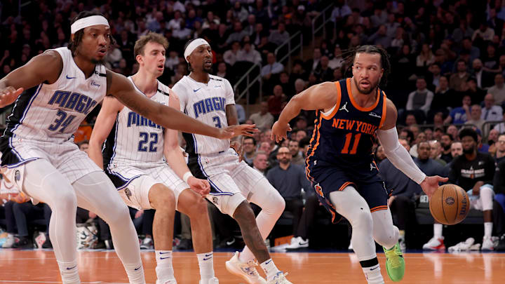 Dec 3, 2024; New York, New York, USA; New York Knicks guard Jalen Brunson (11) looks to pass the ball against Orlando Magic center Wendell Carter Jr. (34) and forward Franz Wagner (22) and guard Kentavious Caldwell-Pope (3) during the third quarter at Madison Square Garden. Mandatory Credit: Brad Penner-Imagn Images