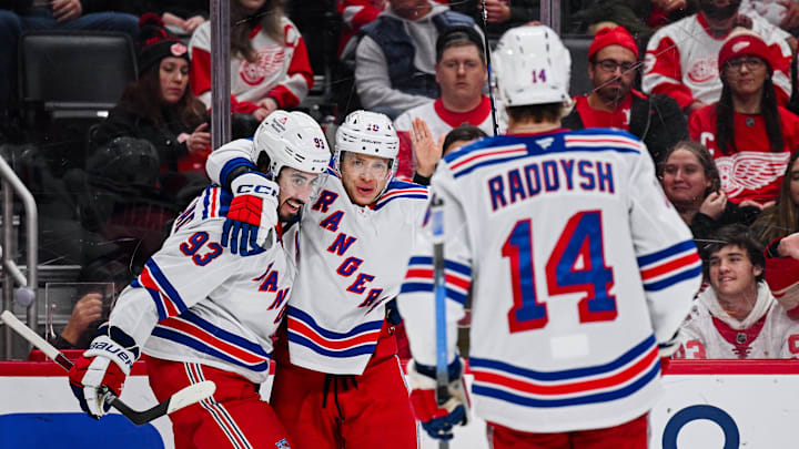 Nov 7, 2025; Detroit, Michigan, USA; New York Rangers left wing Artemi Panarin (10) celebrates his goal with center Mika Zibanejad (93) and right wing Taylor Raddysh (14) during the third period against the Detroit Red Wings at Little Caesars Arena. Mandatory Credit: Tim Fuller-Imagn Images