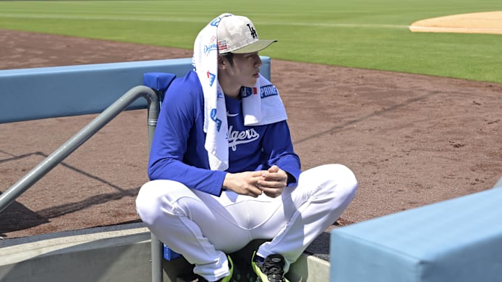 May 18, 2025; Los Angeles, California, USA;  Los Angeles Dodgers starting pitcher Roki Sasaki (11) looks on from the dugout during the game against the Los Angeles Angels at Dodger Stadium. Mandatory Credit: Jayne Kamin-Oncea-Imagn Images