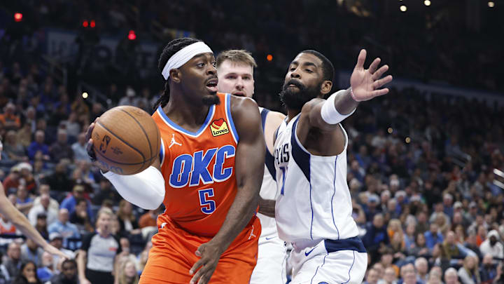 Dec 10, 2024; Oklahoma City, Oklahoma, USA; Dallas Mavericks guard Quentin Grimes (5) passes around Dallas Mavericks guard Kyrie Irving (11) during the second quarter at Paycom Center. Mandatory Credit: Alonzo Adams-Imagn Images Dec 10, 2024; Oklahoma City, Oklahoma, USA; Dallas Mavericks guard Quentin Grimes (5) passes around Dallas Mavericks guard Kyrie Irving (11) during the second quarter at Paycom Center. Mandatory Credit: Alonzo Adams-Imagn Images