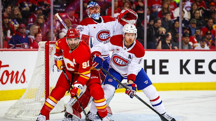 Mar 8, 2025; Calgary, Alberta, CAN; Calgary Flames center Nazem Kadri (91) and Montreal Canadiens defenseman Mike Matheson (8) fights for position in front of Montreal Canadiens goaltender Jakub Dobes (75) during the second period at Scotiabank Saddledome. Mandatory Credit: Sergei Belski-Imagn Images Mar 8, 2025; Calgary, Alberta, CAN; Calgary Flames center Nazem Kadri (91) and Montreal Canadiens defenseman Mike Matheson (8) fights for position in front of Montreal Canadiens goaltender Jakub Dobes (75) during the second period at Scotiabank Saddledome. Mandatory Credit: Sergei Belski-Imagn Images