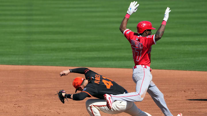 Mar 2, 2025; Scottsdale, Arizona, USA; San Francisco Giants first base Wilmer Flores (41) fields a throw to force out Los Angeles Angels shortstop Tim Anderson (77) at first base during the third inning at Scottsdale Stadium. Mandatory Credit: Joe Camporeale-Imagn Images