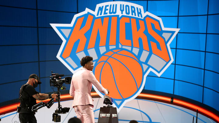 Jul 29, 2021; Brooklyn, New York, USA; Kai Jones (Texas) grabs his Knicks cap after being selected as the number nineteen overall pick by the New York Knicks in the first round of the 2021 NBA Draft at Barclays Center. Mandatory Credit: Brad Penner-Imagn Images