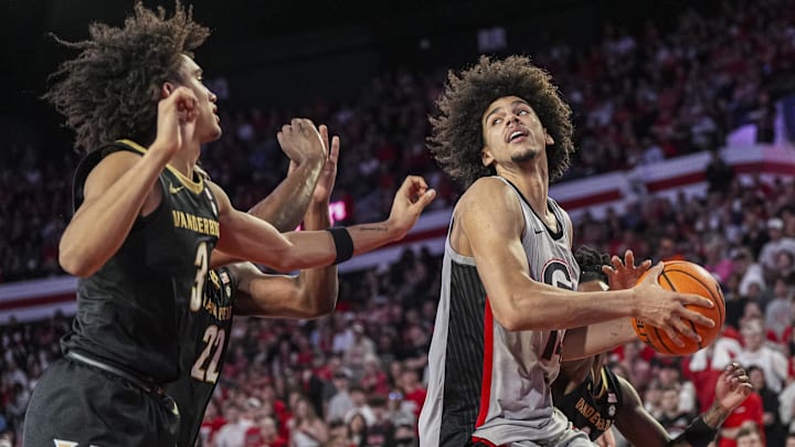 Mar 8, 2025; Athens, Georgia, USA; Georgia Bulldogs forward Asa Newell (14) controls the ball behind Vanderbilt Commodores guard Tyler Tanner (3) during the first half at Stegeman Coliseum. Mandatory Credit: Dale Zanine-Imagn Images