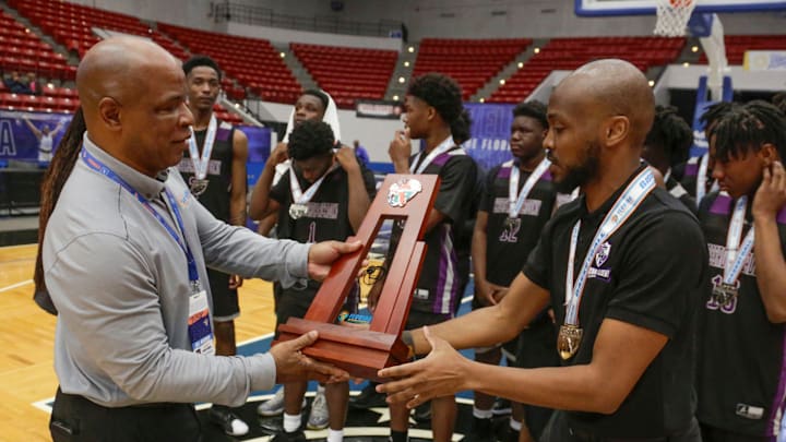 FHSAA Executive Director Craig Damon awards Crossroad Academy coach Colin Anderson the runner up trophy. Hawthorne HS defeated Crossroad Academy 59-38 in the FHSAA Rural State Boys basketball Championship game at the RP Funding Center in Lakeland Fl. February 28th 2025. Photos special to the Ledger / Calvin Knight