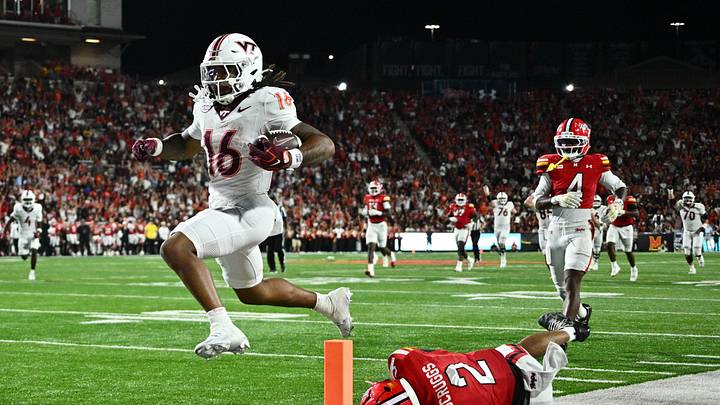Sep 19, 2026; College Park, Maryland, USA; Virginia Tech Hokies running back Jeffrey Overton, Jr. (16) leaps out of the grasp of Maryland Terrapins defensive back Lavain Scruggs (2) to score a touchdown in the first half at SECU Stadium. Mandatory Credit: Jamie Sabau-Imagn Images Sep 19, 2026; College Park, Maryland, USA; Virginia Tech Hokies running back Jeffrey Overton, Jr. (16) leaps out of the grasp of Maryland Terrapins defensive back Lavain Scruggs (2) to score a touchdown in the first half at SECU Stadium. Mandatory Credit: Jamie Sabau-Imagn Images